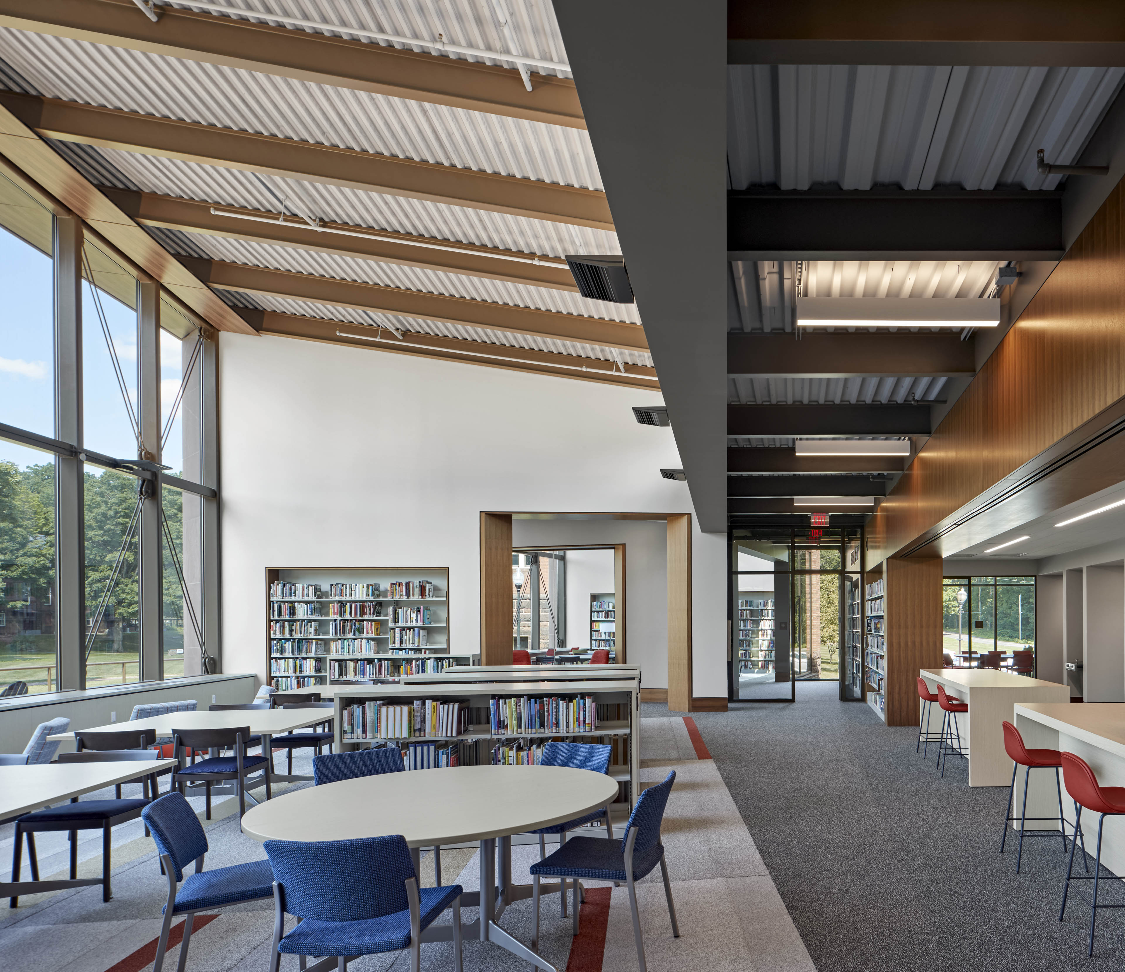 Library seating area with windows on back wall and windows to left