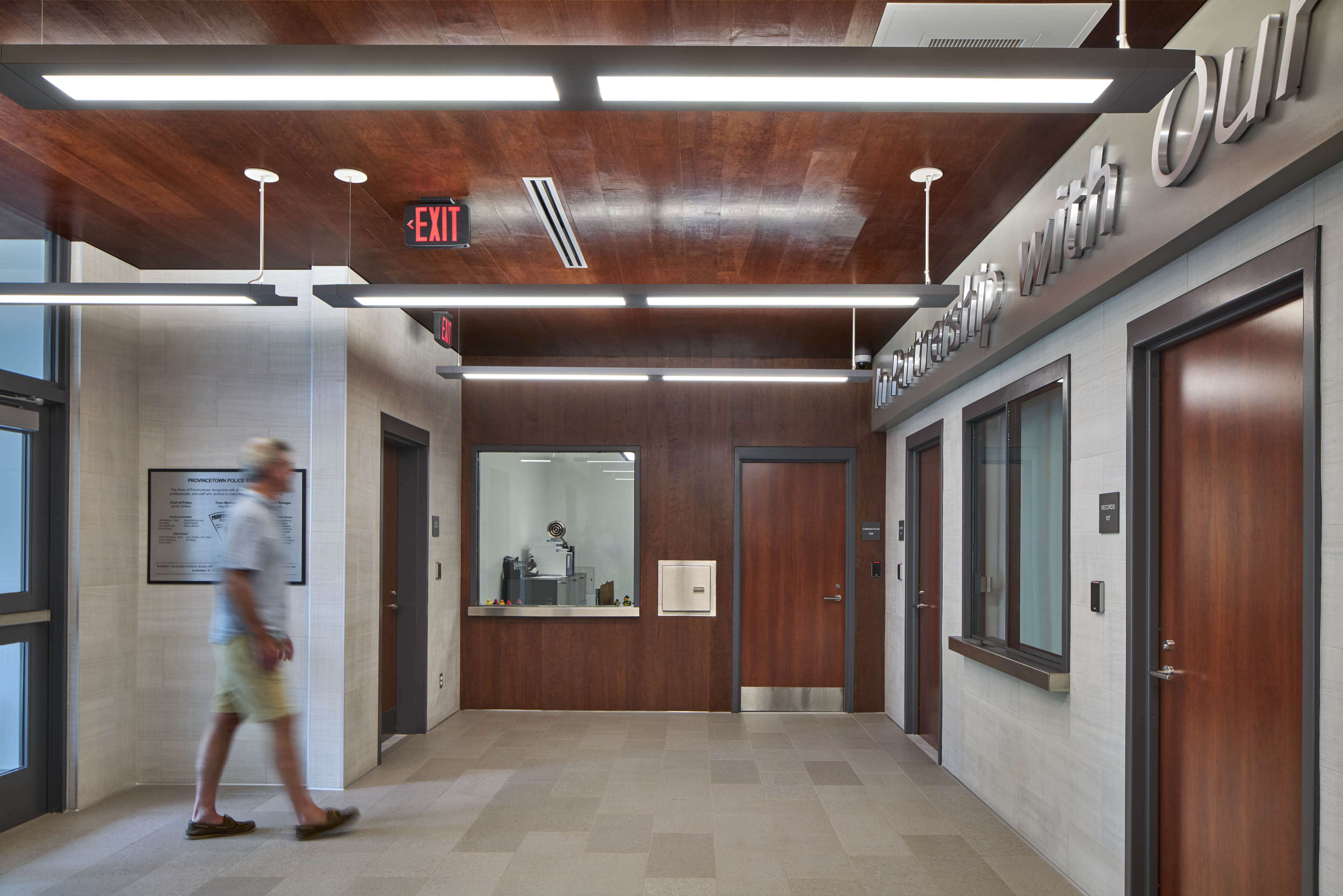 Entrance area of building with dark red brown wood and window booths