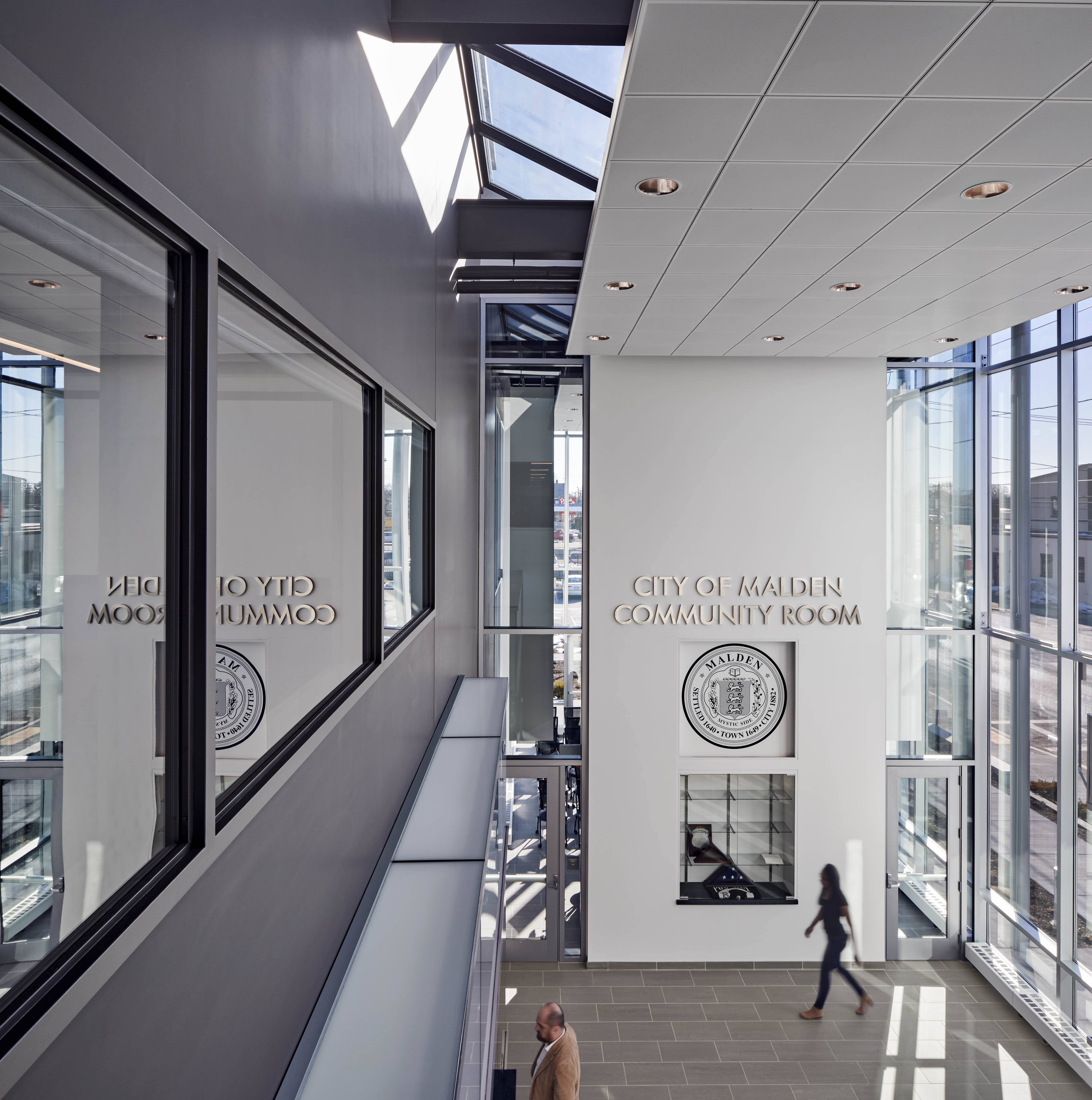 View from top floor looking out to community room with police crest on back wall