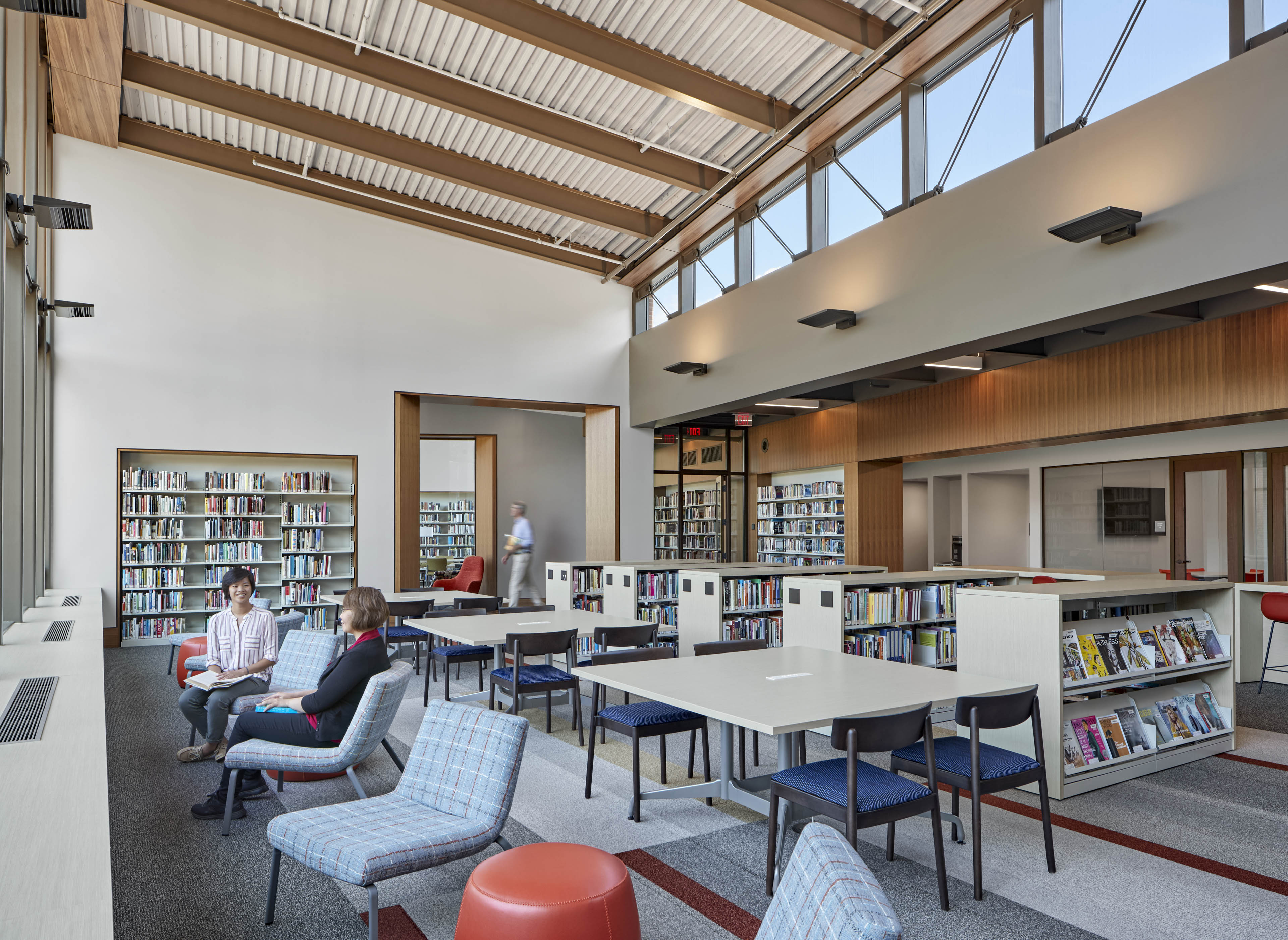 Library with lounge seating in front and book shelves to the right
