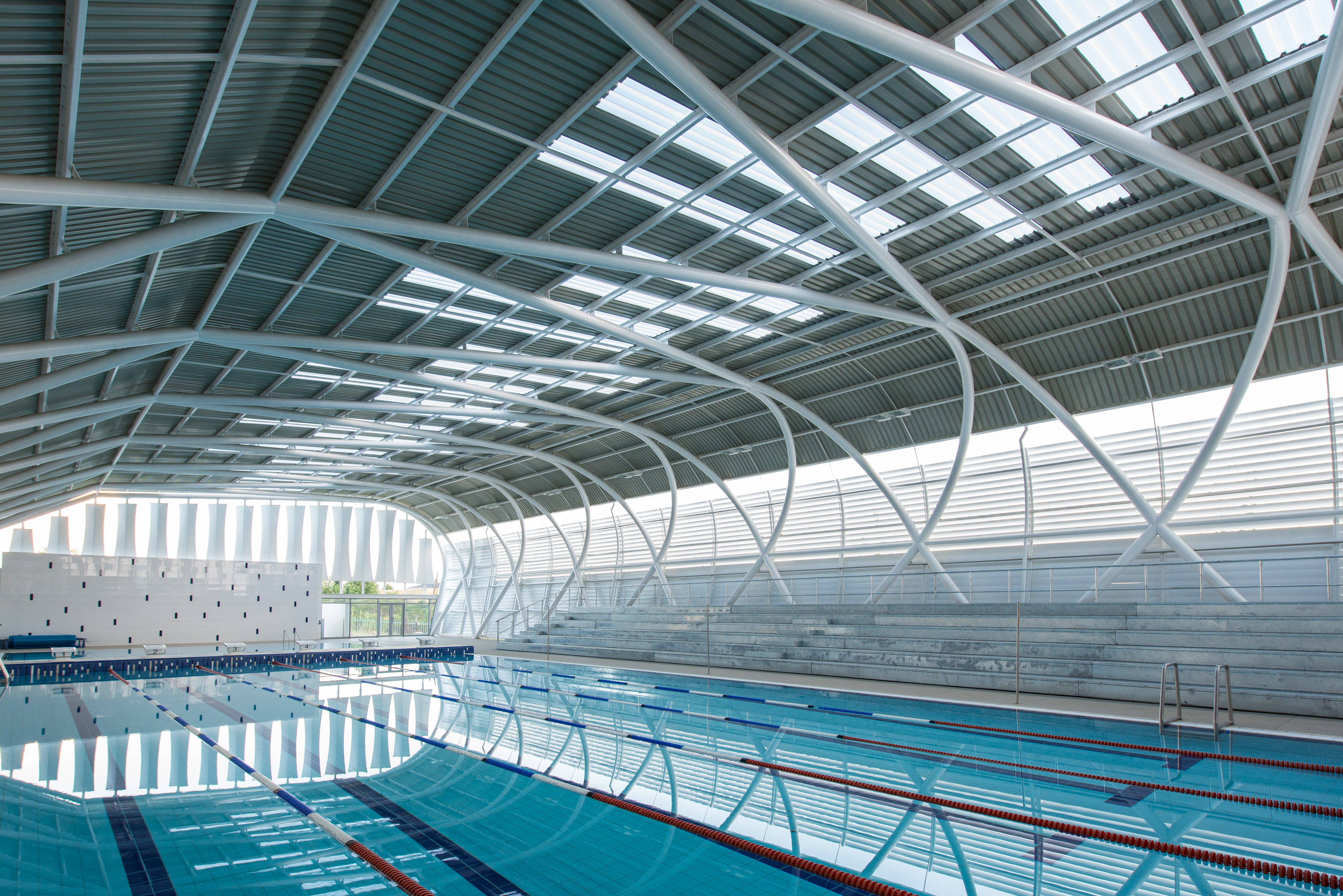 Indoor pool with lane lines and ample sunglight