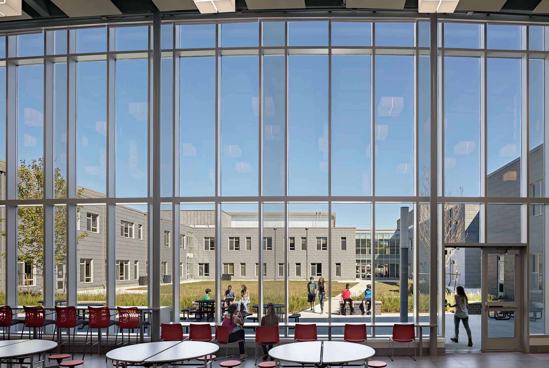Cafeteria Windows overlooking quad with green grass and other side of school