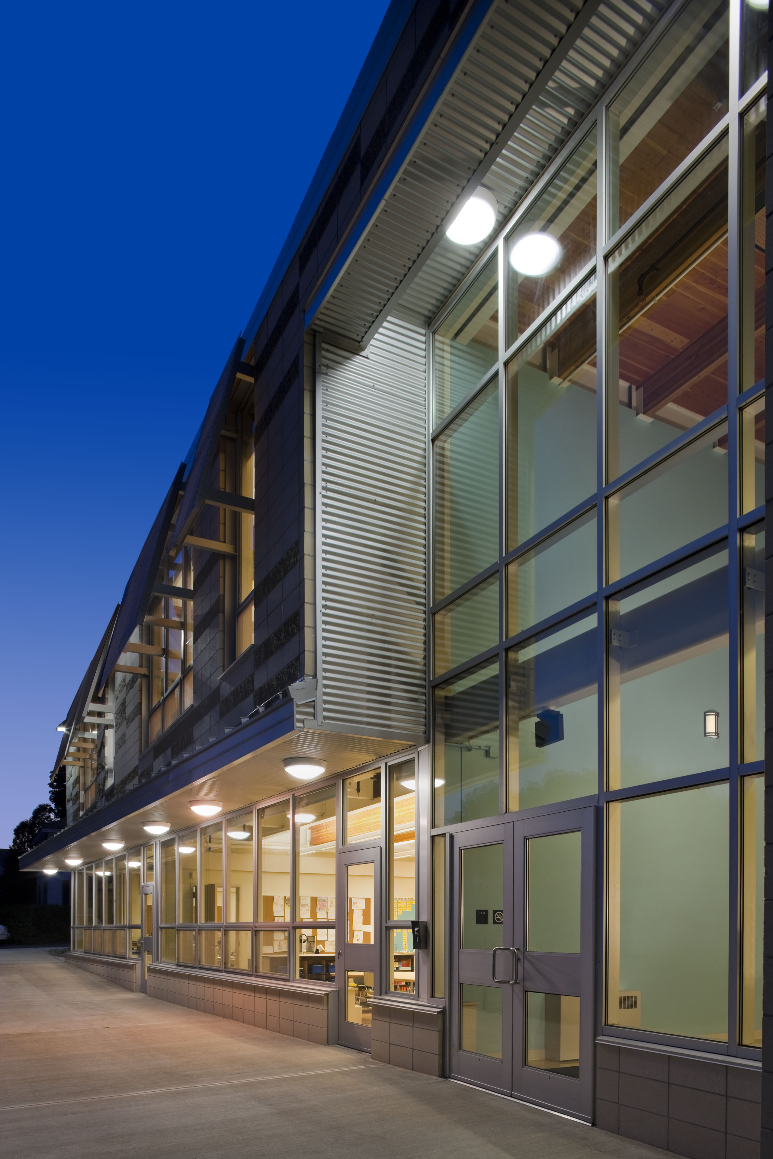 Nighttime view of building with windows covering most of building