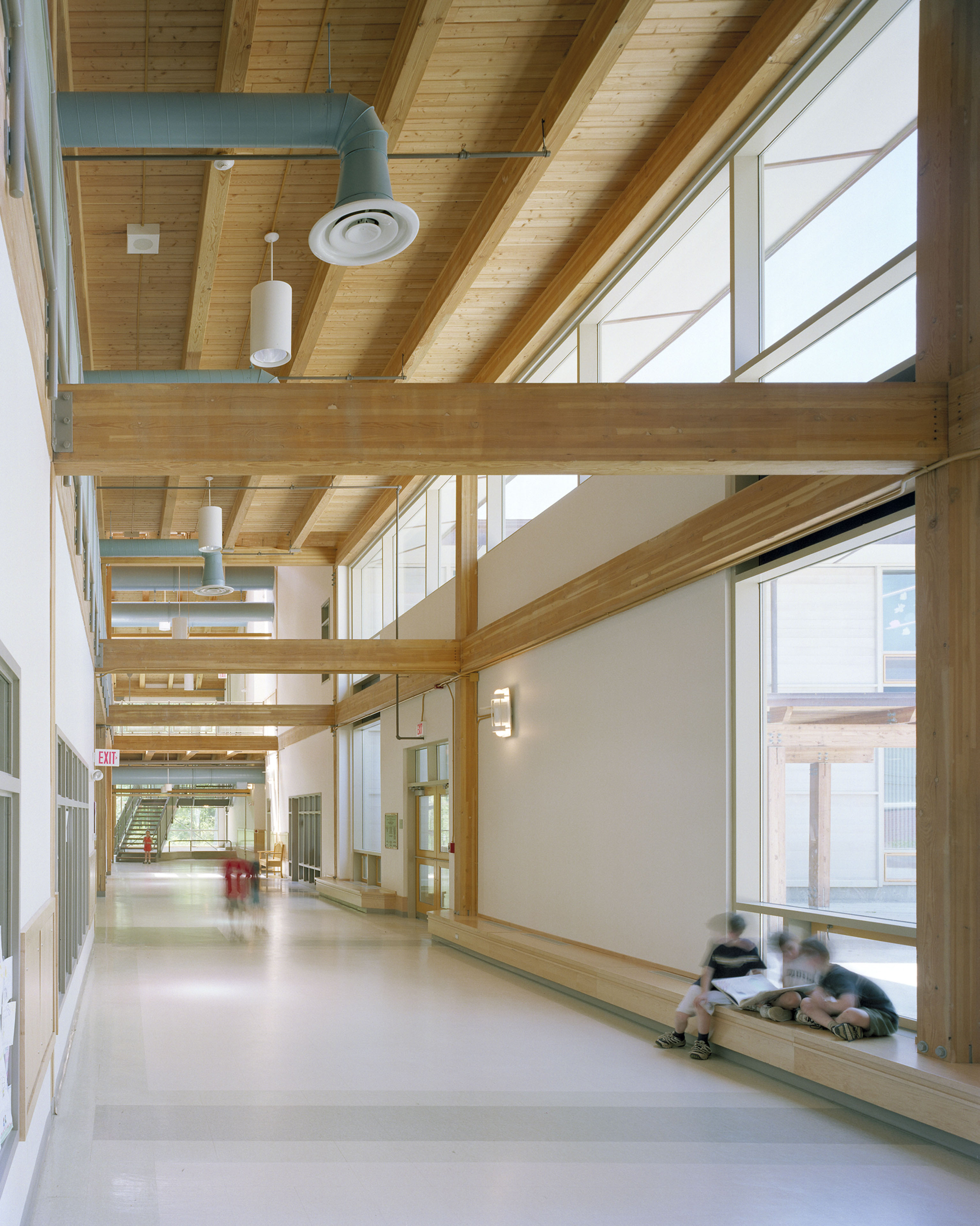 Interior corridor with large wood beams vertically and horizontally  
