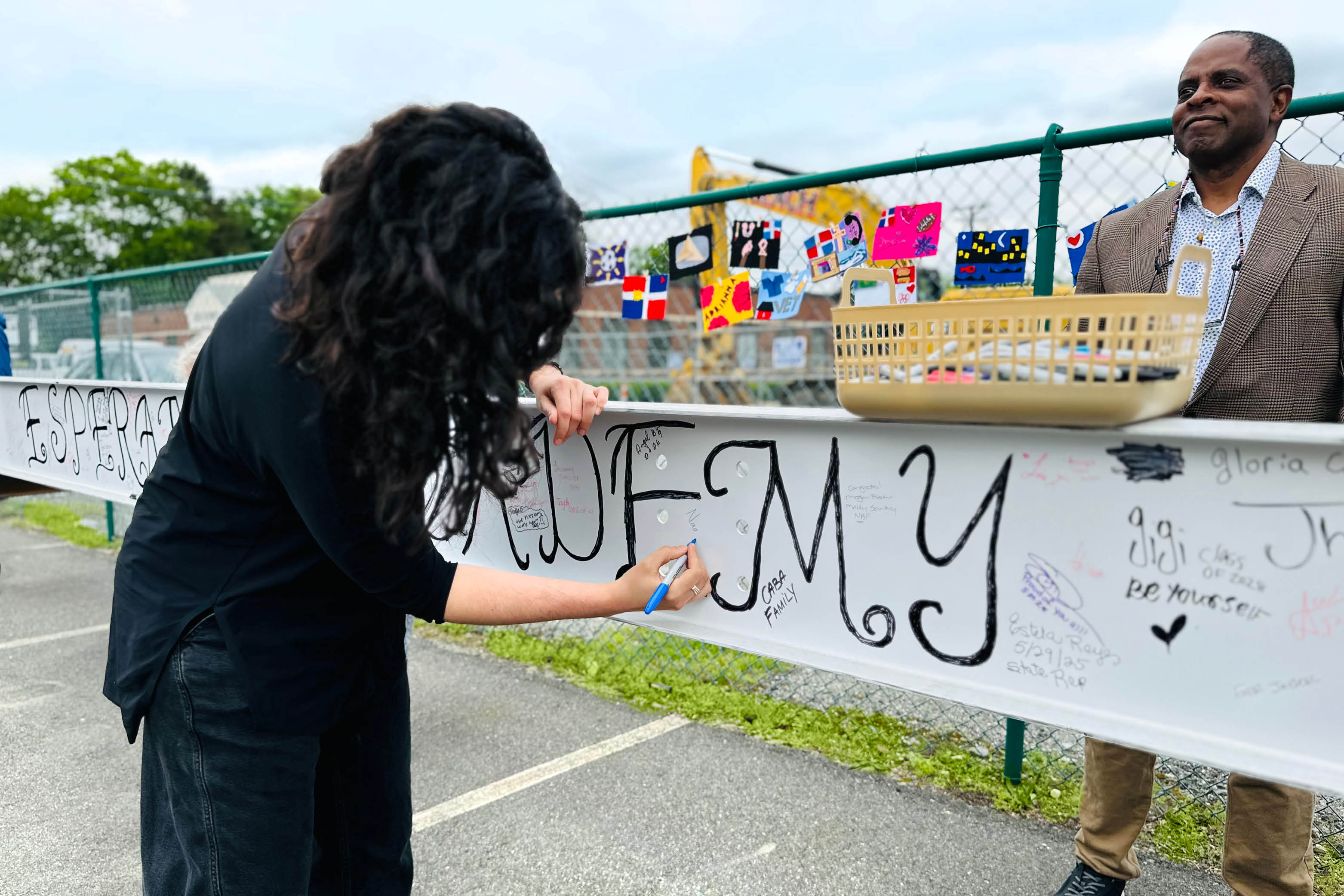 Naomi Levine signs the final beam at Esperanza Academy’s Ground Blessing and Beam Signing Ceremony