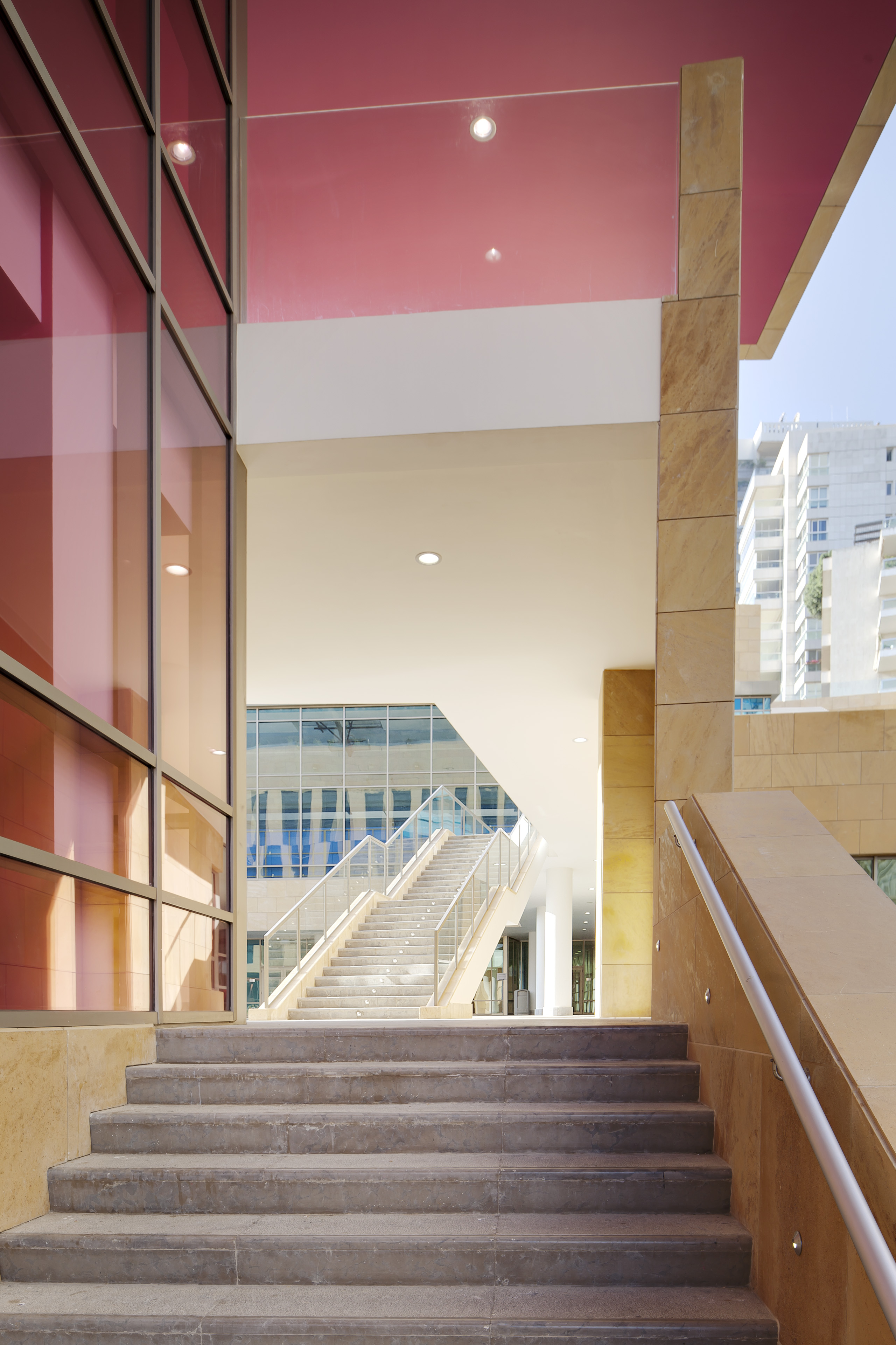 View from exterior corridor with stairs in back and red awning above