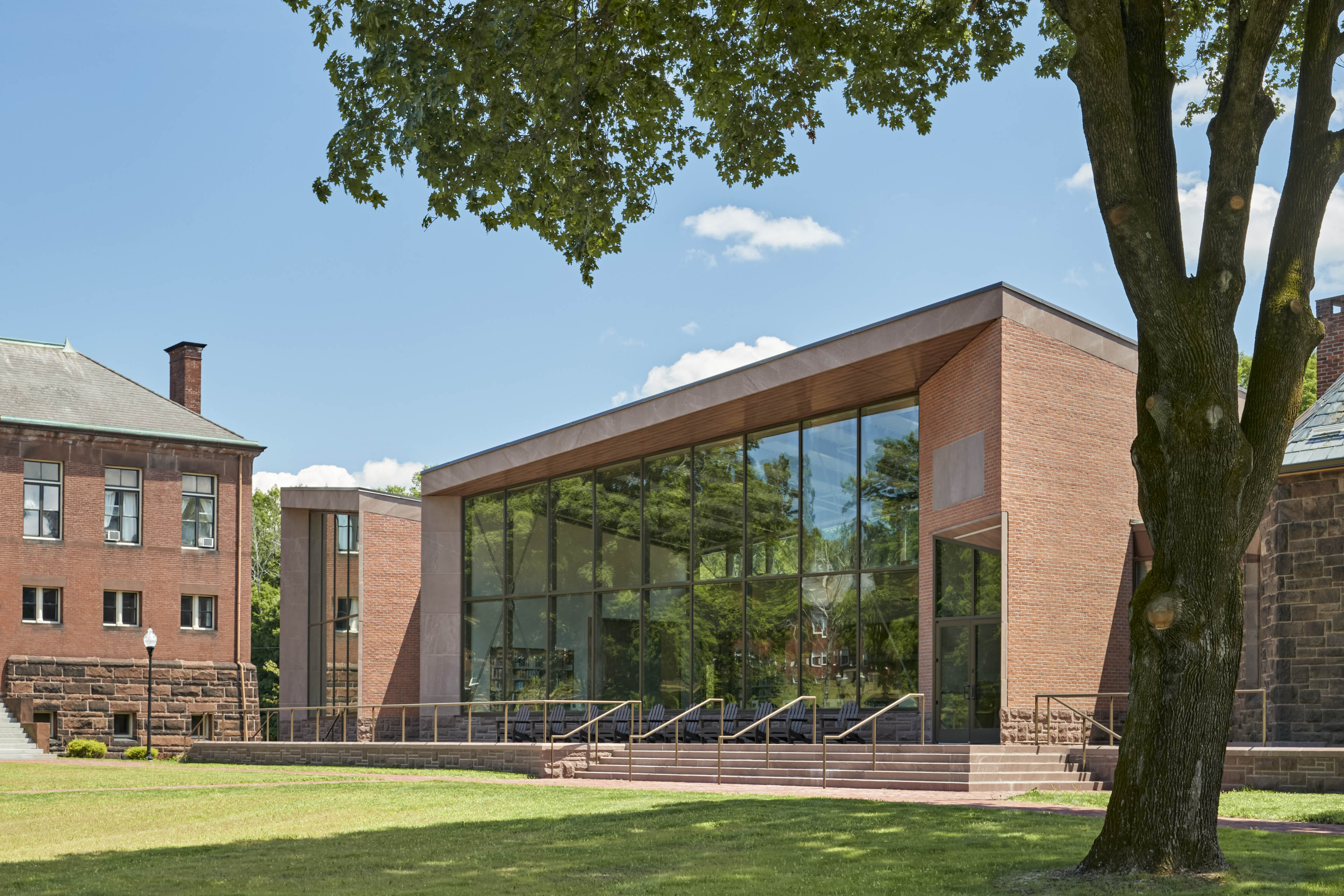 View of entrance with large vertical windows and stairs leading up