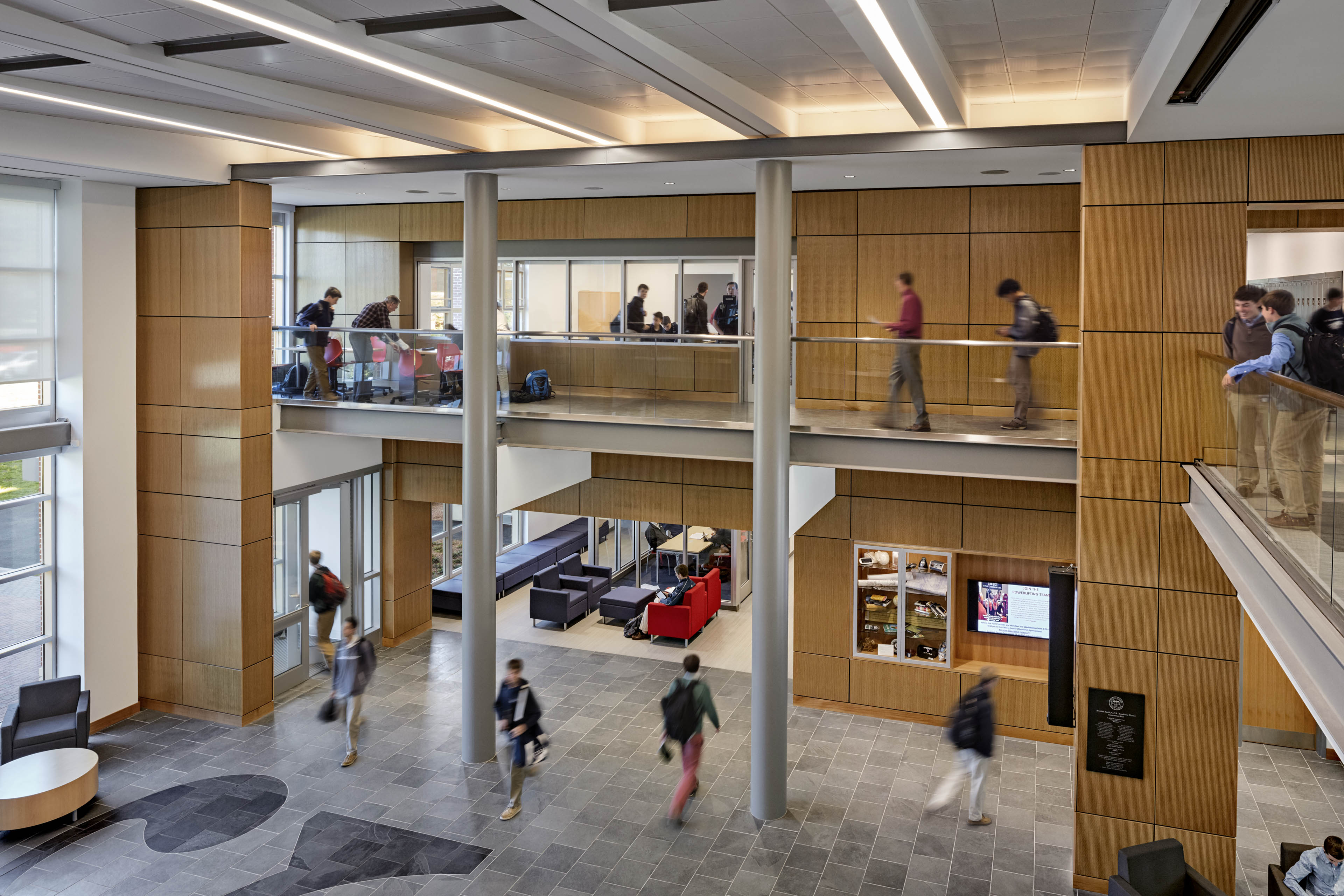 View from second floor balcony looking down at students walking around common area