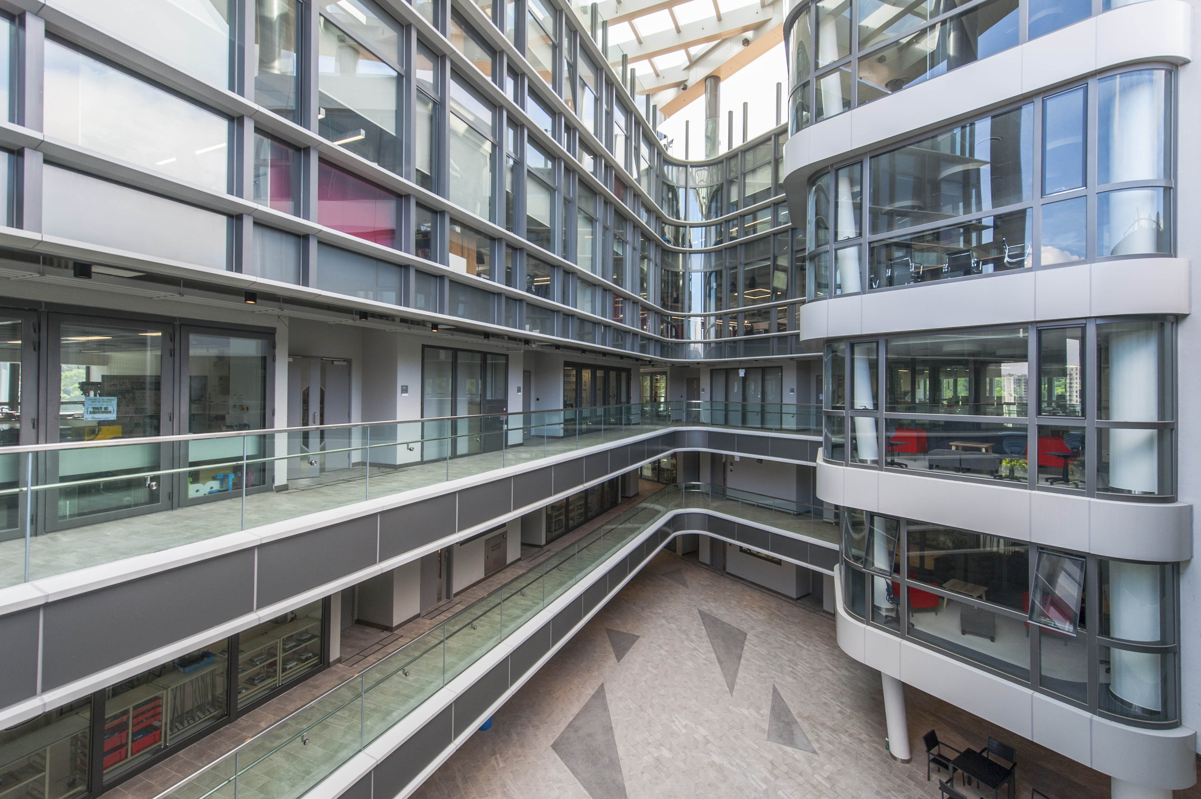 View of exterior courtyard looking onto different floors. Windows cover each floor