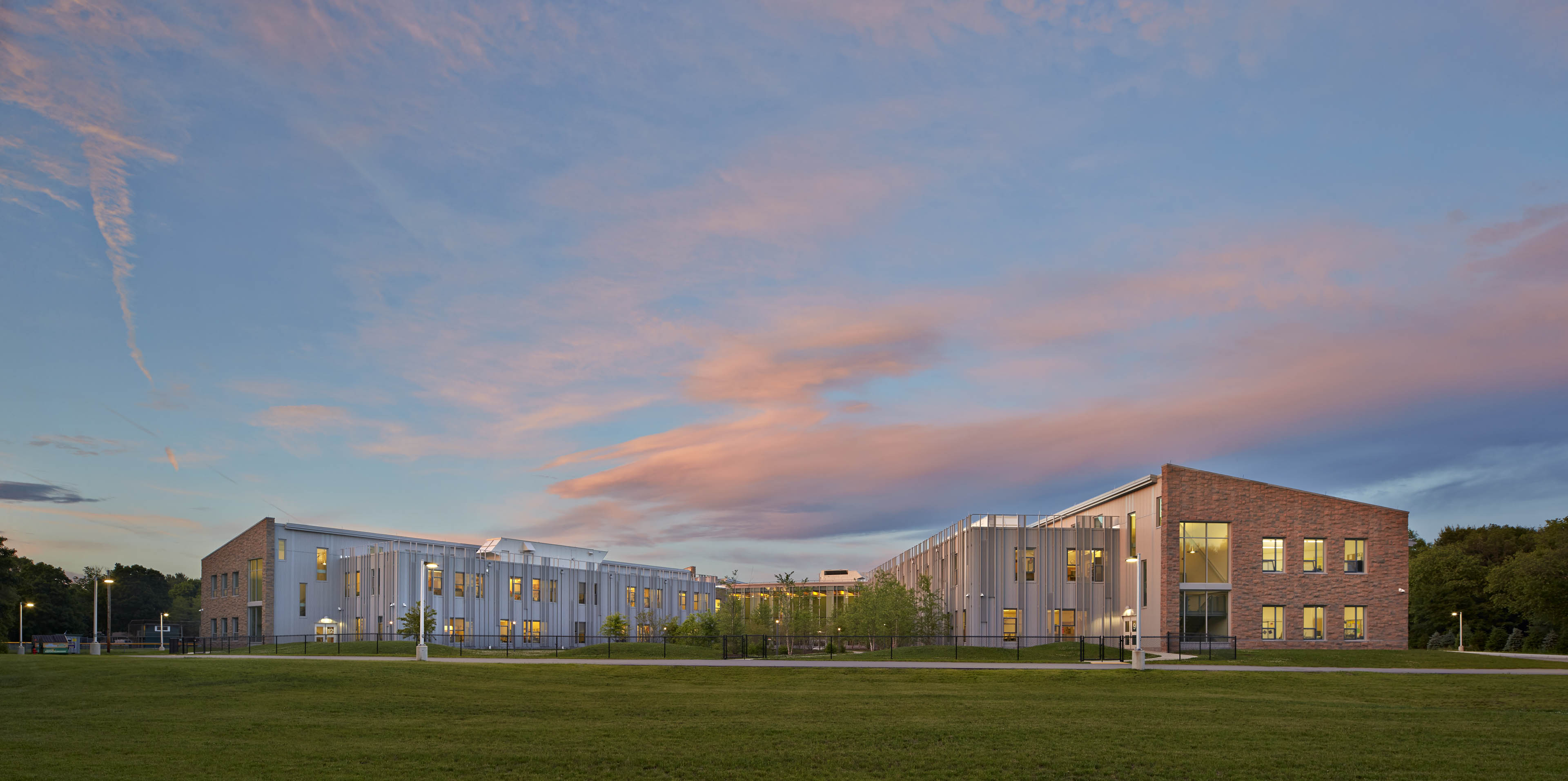 View of school at sunset from grassy field